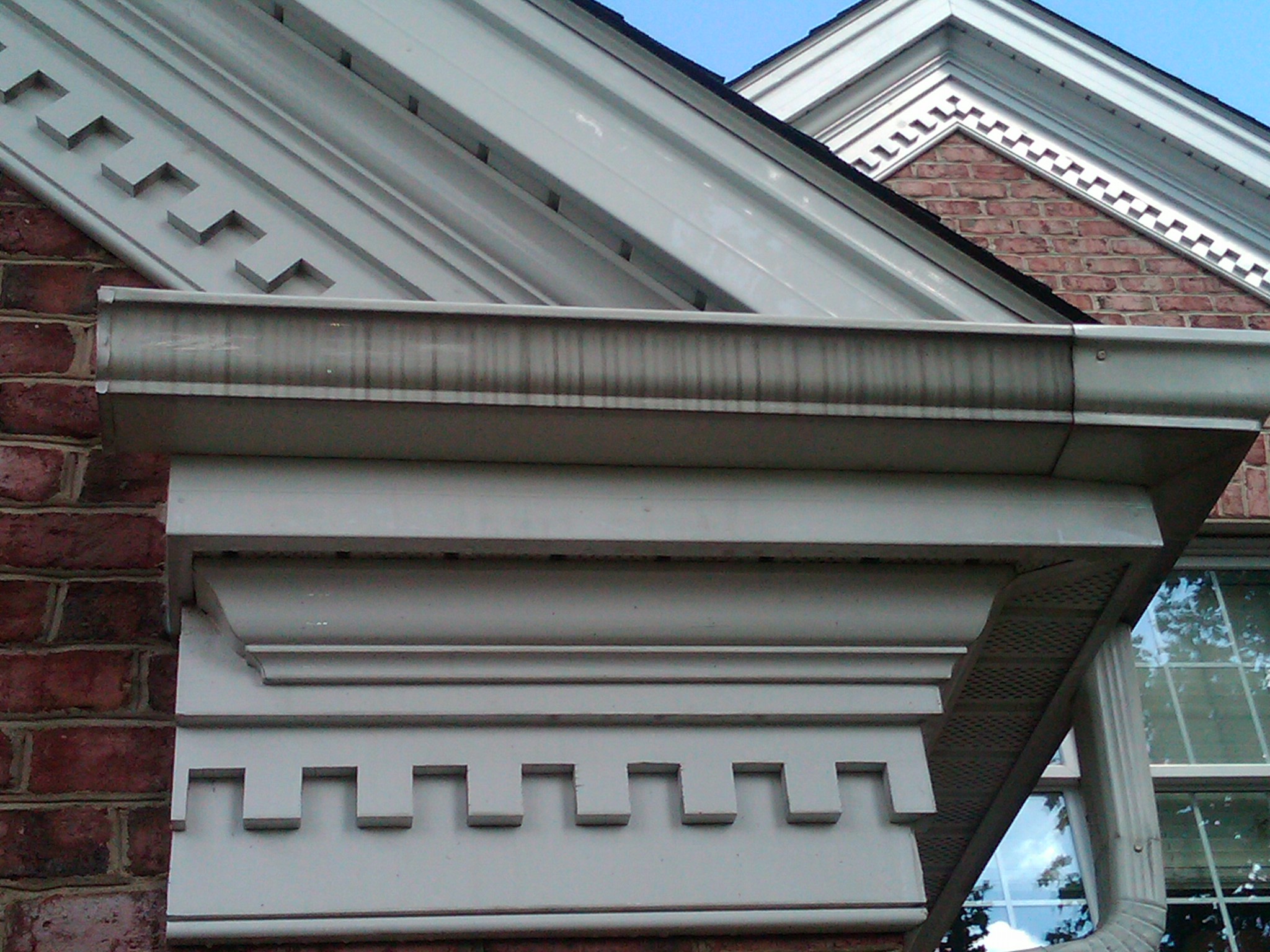 Typical black stained streaks on outside of rain gutter.