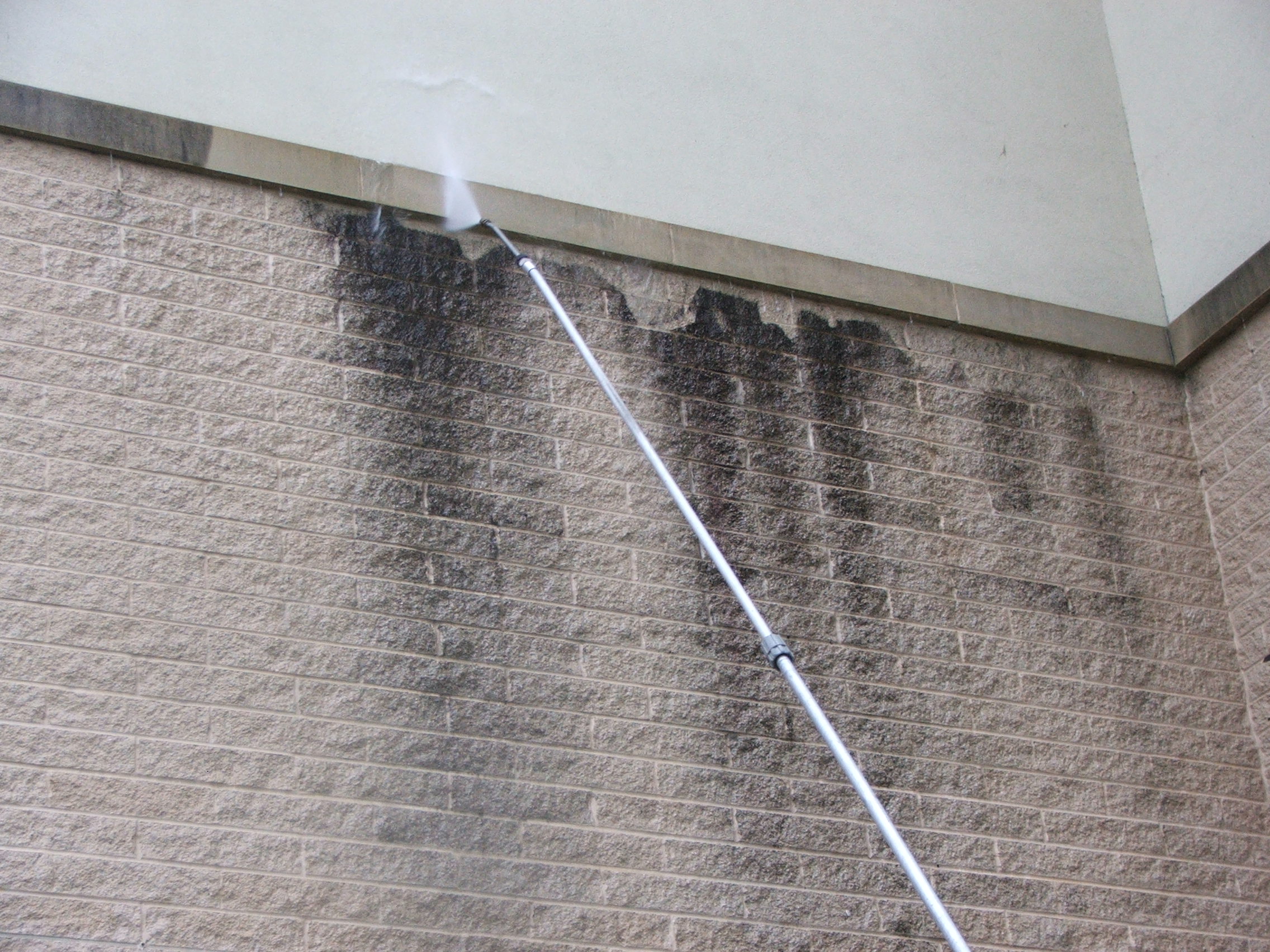 Masonry block wall pressure washing to remove black stains at a nursing home in Harrisburg.
